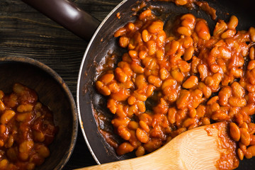 Beans in tomato in a frying pan. A delicious dish.