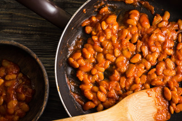 Beans in tomato in a frying pan. A delicious dish.