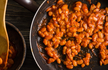 Beans in tomato in a frying pan. A delicious dish.