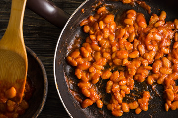 Beans in tomato in a frying pan. A delicious dish.