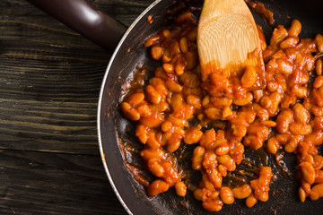 Beans in tomato in a frying pan. A delicious dish.