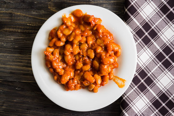 Beans in tomato in a white plate. A delicious dish.