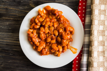 Beans in tomato in a white plate. A delicious dish.