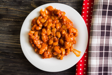 Beans in tomato in a white plate. A delicious dish.