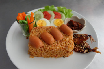 Fried rice with vegetable,fish,egg and sausage.