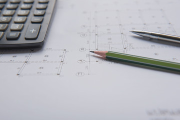 pencil  pen and calculator on blueprints. Architectural and engineering housing concept.