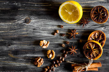 Dried slices of lemon, coffee beans, dried fruits and nuts on a wooden table. Natural product.