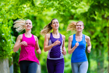 Women in forest running for sport