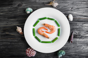 Shrimps with vegetables on a wooden table in rustic style