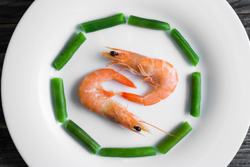 Shrimps with vegetables on a wooden table in rustic style