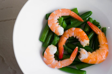 Shrimps with vegetables on a wooden table in rustic style