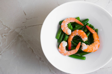 Shrimps with vegetables on a wooden table in rustic style