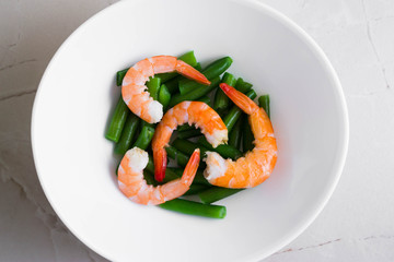 Shrimps with vegetables on a wooden table in rustic style