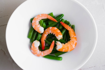 Shrimps with vegetables on a wooden table in rustic style