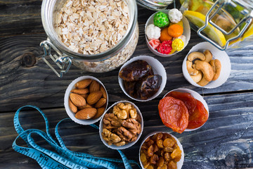 Nuts and dried fruit to the diet on a wooden table in rustic style