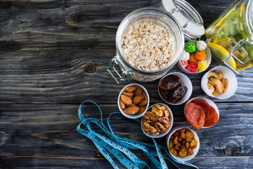 Nuts and dried fruit to the diet on a wooden table in rustic style