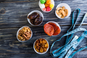 Nuts and dried fruit to the diet on a wooden table in rustic style
