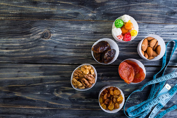 Nuts and dried fruit to the diet on a wooden table in rustic style