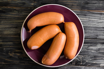 Sausages on a wooden background in rustic style