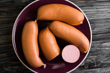 Sausages on a wooden background in rustic style