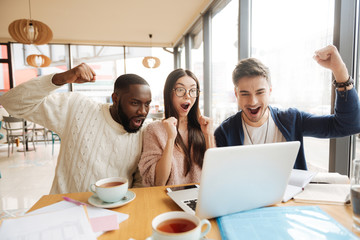Positive international students hving fun in the cafe