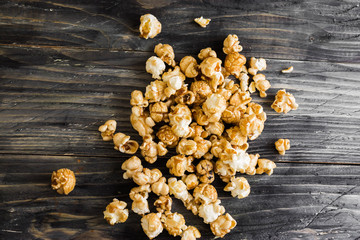Sweet popcorn on a wooden table. Delicious dessert.