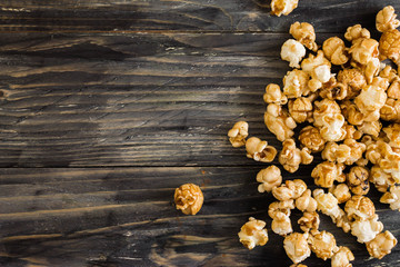 Sweet popcorn on a wooden table. Delicious dessert.
