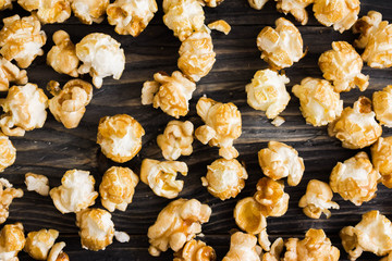 Sweet popcorn on a wooden table. Delicious dessert.