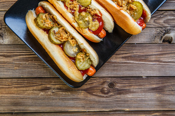 American hot dog with pickles,onions, ketchup and mustard