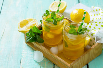 Refreshing summer drink cold tea with lemon and mint. The concept of healthy and dietary nutrition.