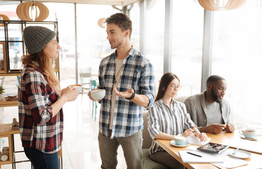 Fototapeta premium Nice guy and girl having conversation in the cafe