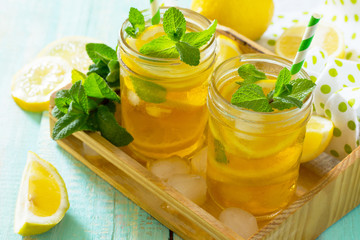 Refreshing summer drink cold tea with lemon and mint. The concept of healthy and dietary nutrition.