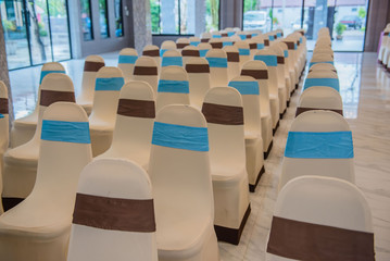 Beautiful decorated chairs in the room . Empty hall for presentation.