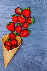 Healthy ice-cream. Healthy food: Strawberries in wafer cup isolated on grey background