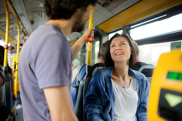 Young couple in inside of the city bus.