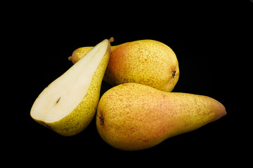Pears of yellow color on a black background (closeup). Option 3