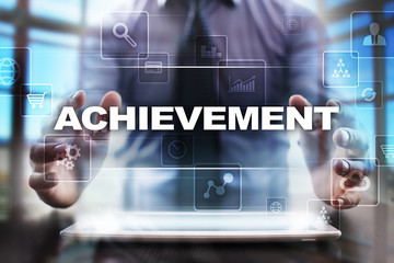 Businessman using tablet pc and selecting achievement.