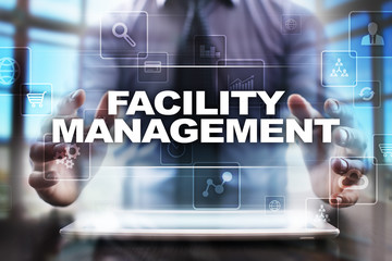 Businessman using tablet pc and selecting facility management.