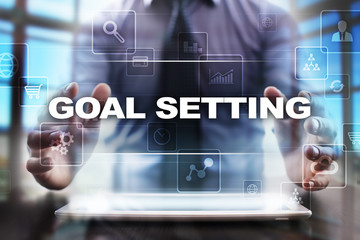 Businessman using tablet pc and selecting goal setting.