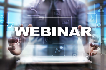 Businessman using tablet pc and selecting webinar.