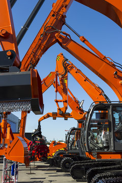 Bulldozer, Excavator, Tractor, Front End Loader And Other Orange Construction Machines With Scoop, Shovel, Jackhammer And Another Equipment In Row, Heavy Industry, Blue On Background