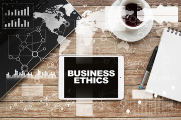 Tablet on desktop with business ethics text.
