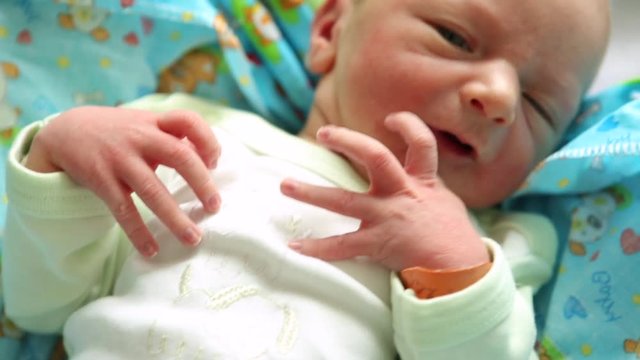 ugly newborn baby with tiny hand in focus. shaking hands