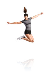 Fototapeta na wymiar Young fitness woman jumping high. Studio shot, isolated.