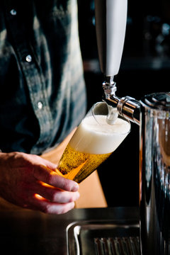 Man pouring beer into glass 