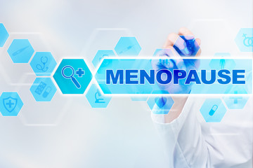 Fototapeta na wymiar Medical doctor drawing menopause on the virtual screen.