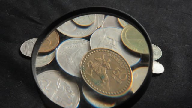 to see the collection of coins through a magnifying glass