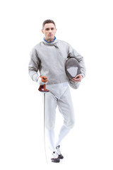 Young confident man professional fencer standing with helmet and rapier