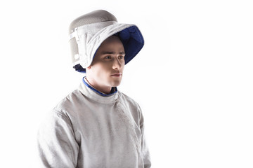 portrait of serious fencer in mask and uniform for training on white
