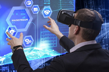 Business, Technology, Internet and network concept. Young businessman working on a virtual screen of the future and sees the inscription: Mainstream